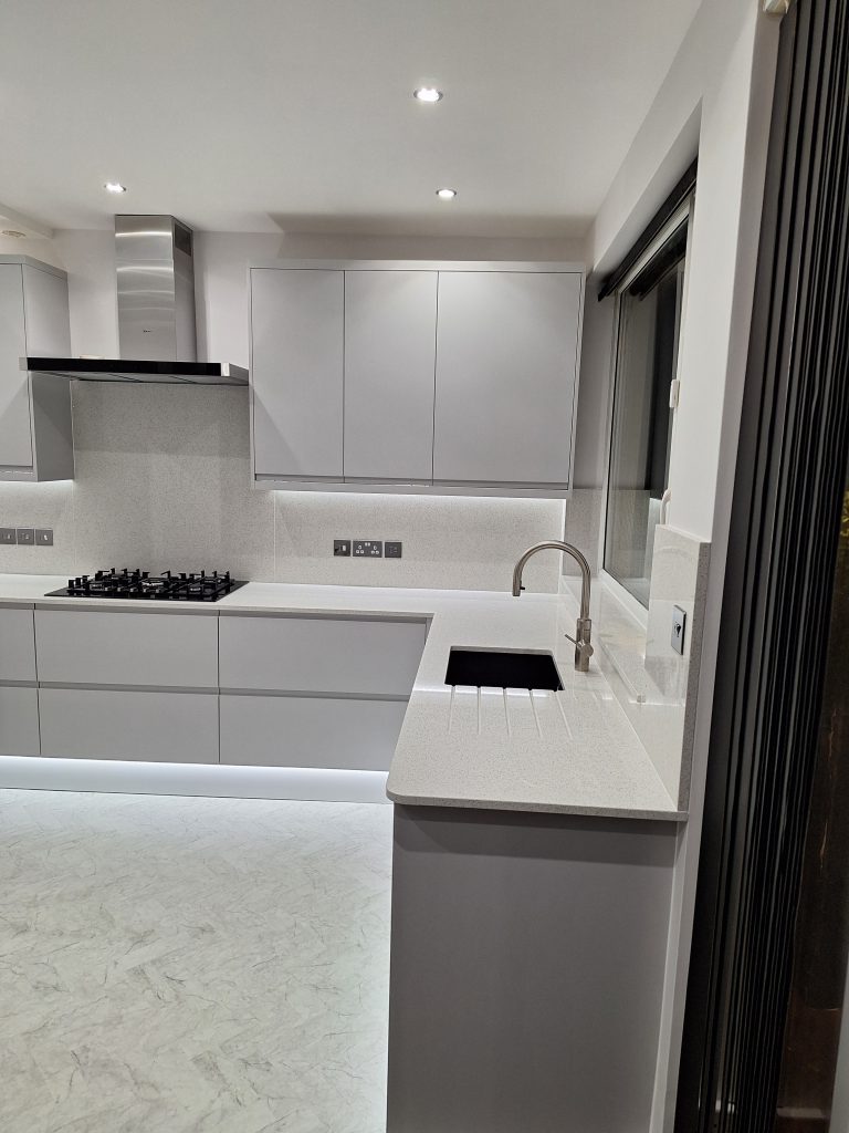 Grey kitchen with inset sink and pale worktop