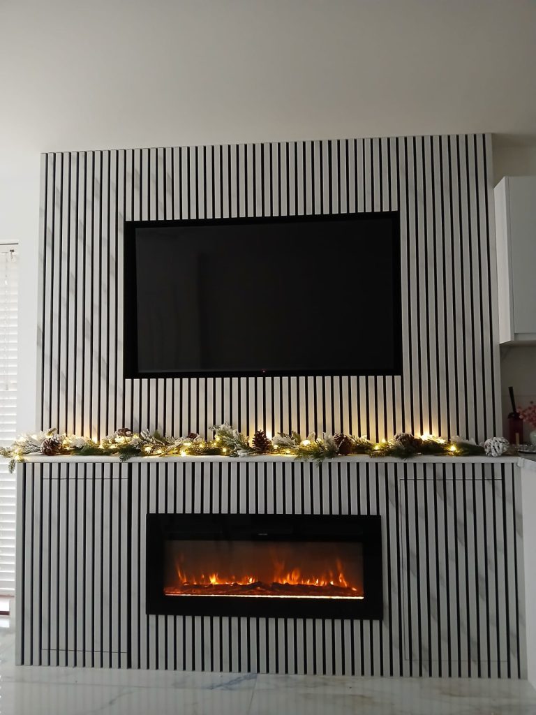 Slatted media wall with television and electric fireplace