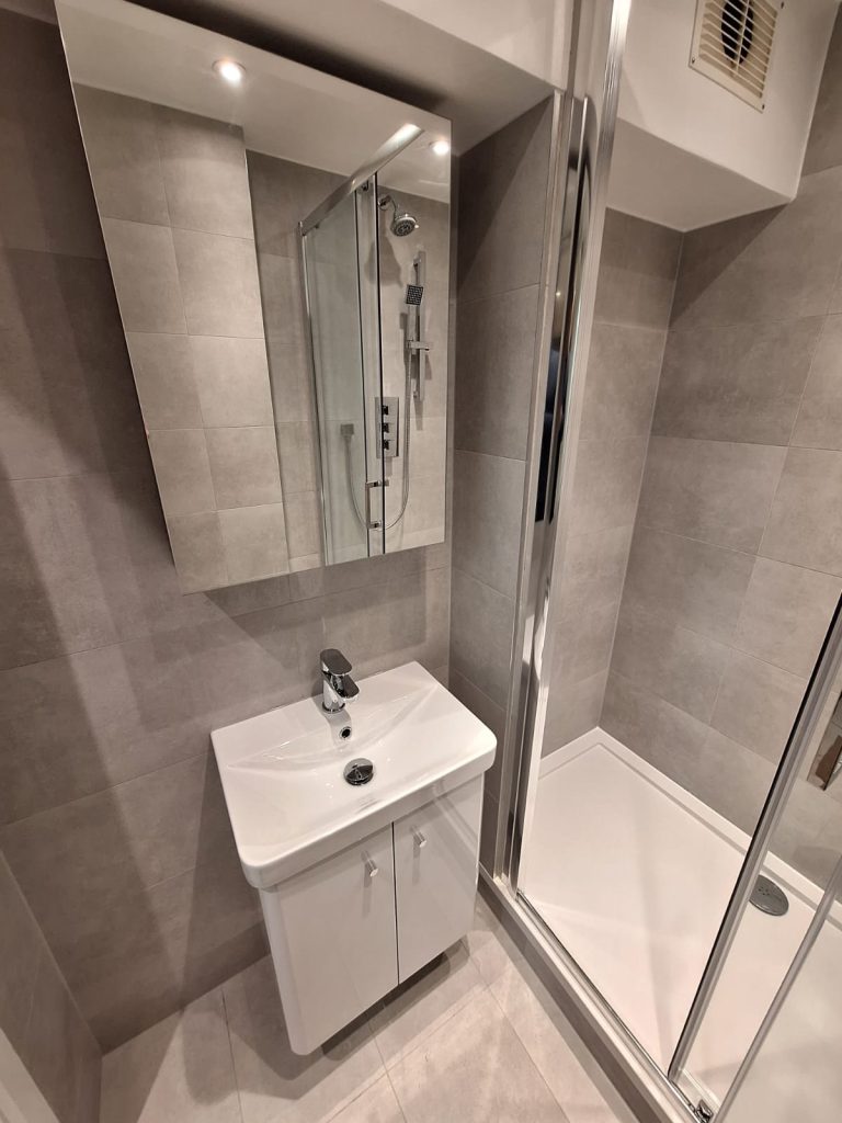 Compact white vanity and mirrored cabinet